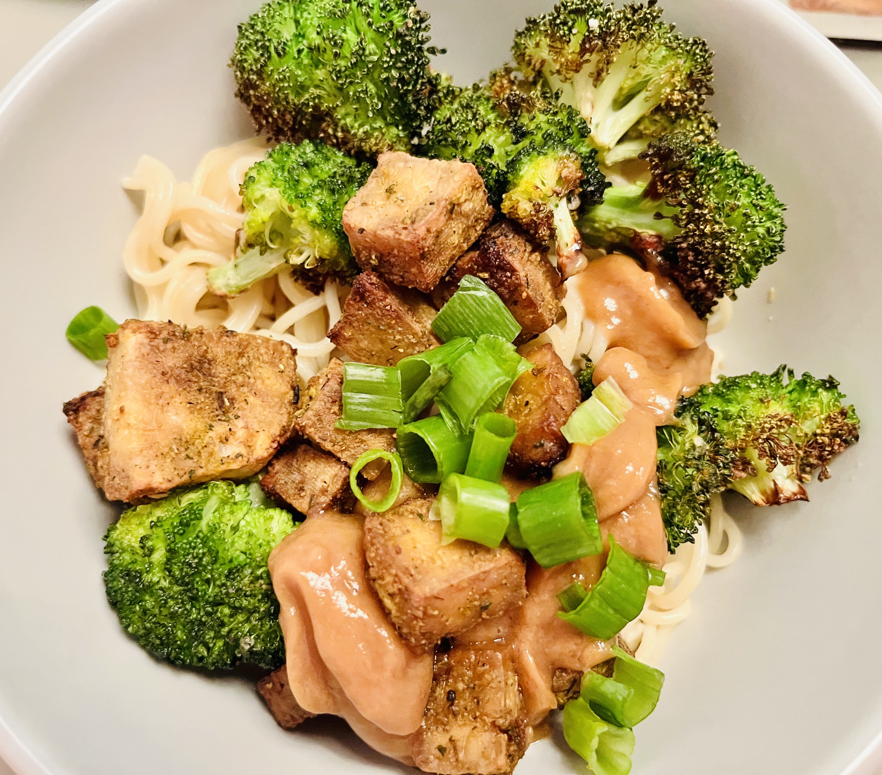 Air-fried tofu and broccoli over ramen with peanut sauce