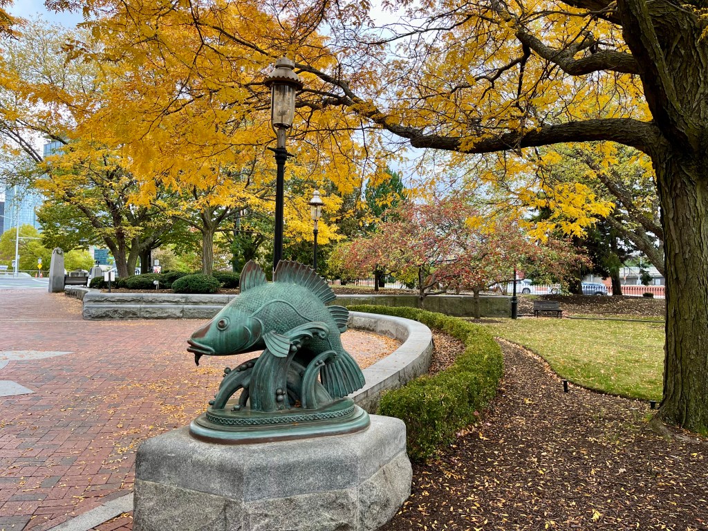 Fish statue and autumn foliage Boston
